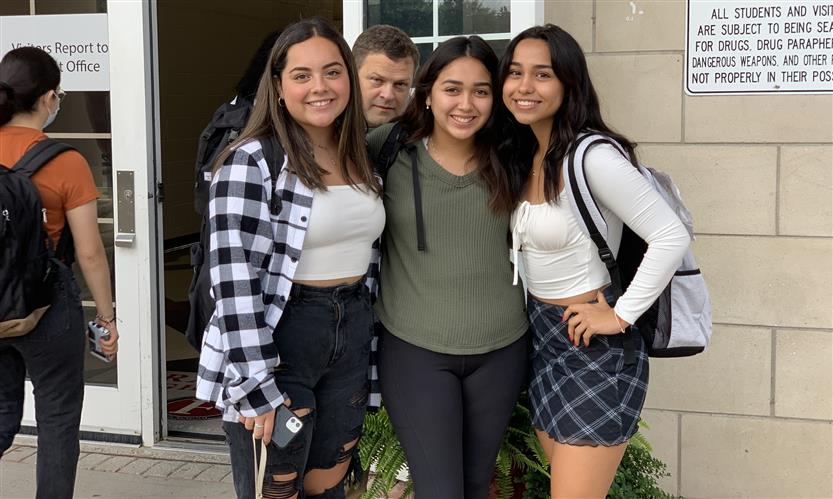 A group of students smiles